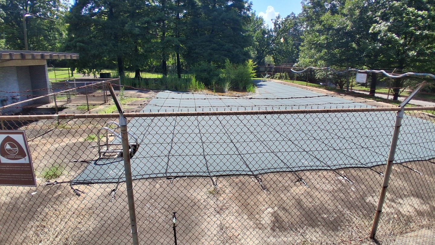 Before: a closed neighborhood pool restored and full of children swimming on a summer afternoon