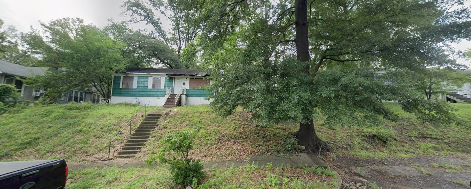 Before: a boarded-up Northside house fully renovated and a new infill cottage built on the vacant lot beside it